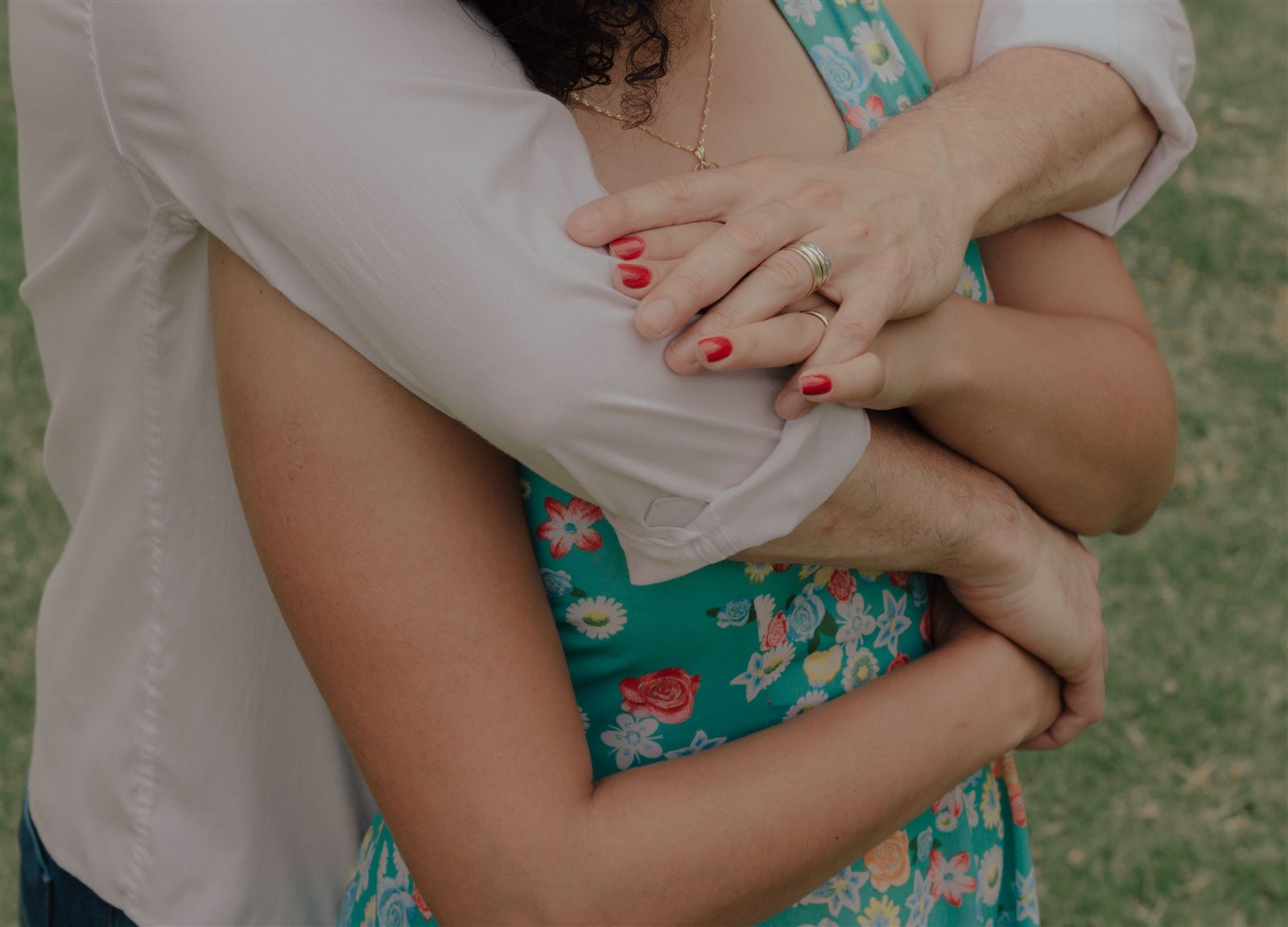 Pareja abrazada, con las manos entrelazadas